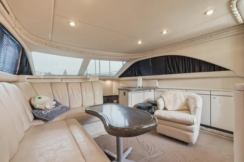Slide: The Image of Luxurious interior of 1997 Sea Ray 370 Aft Cabin yacht with plush seating and elegant decor. - 25