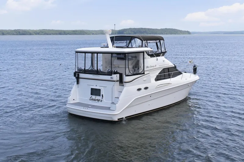 Slide: The Image of 1997 Sea Ray 370 Aft Cabin yacht on open water under a clear blue sky. - 2