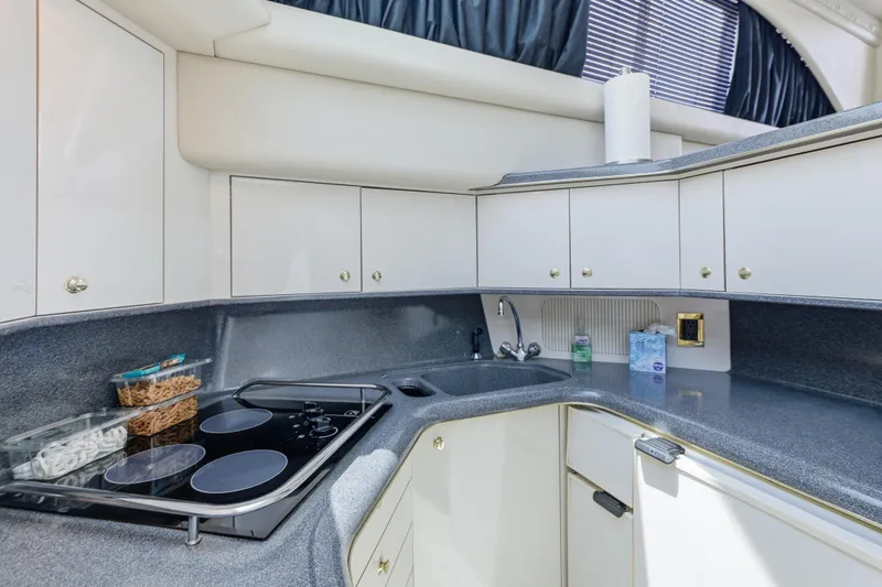 Slide: The Image of Modern kitchen in 1997 Sea Ray 370 Aft Cabin yacht with sleek countertops and appliances. - 37