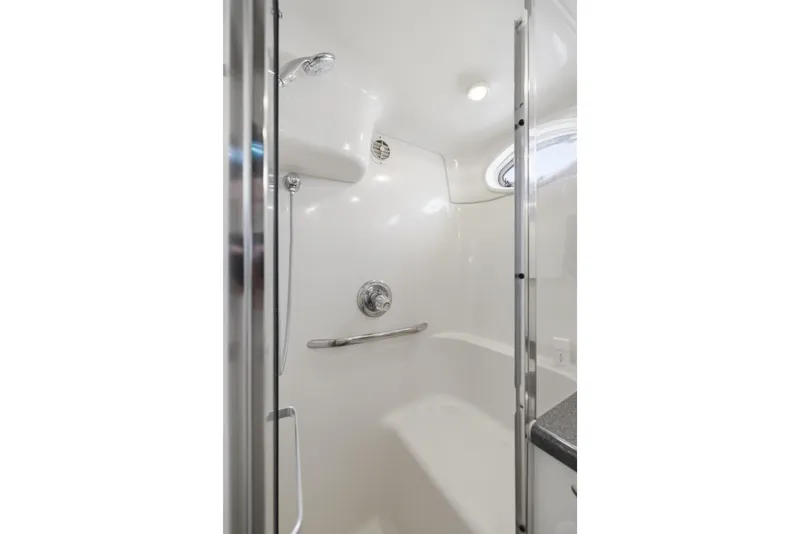 Slide: The Image of Shower area in 1997 Sea Ray 370 Aft Cabin yacht, featuring sleek white design and chrome fixtures. - 42