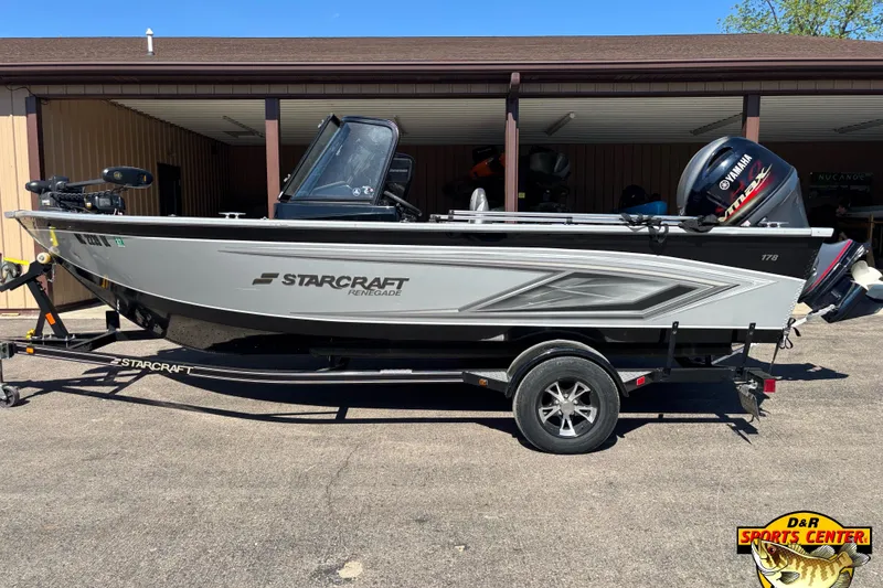 Slide: The Image of 2020 Starcraft Renegade 178 DC boat on trailer, parked outside a building. - 2