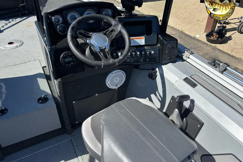 Slide: The Image of 2020 Starcraft Renegade 178 DC boat cockpit with steering wheel and control panel. - 7