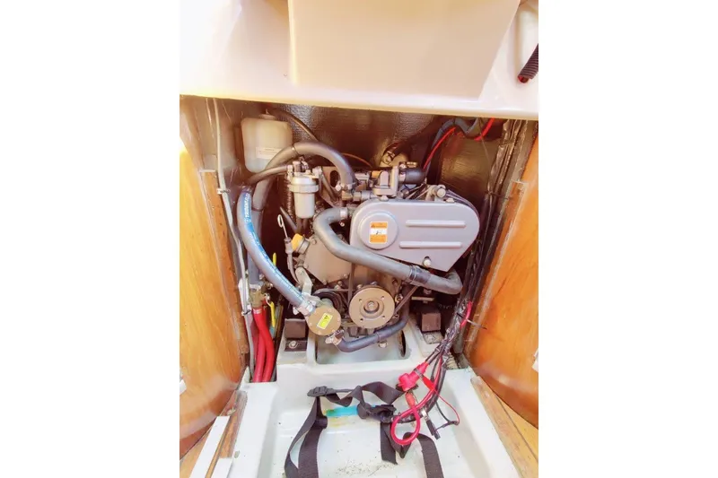 Slide: The Image of Engine compartment of a 1991 Beneteau First 38s5 sailboat, showcasing mechanical components. - 11