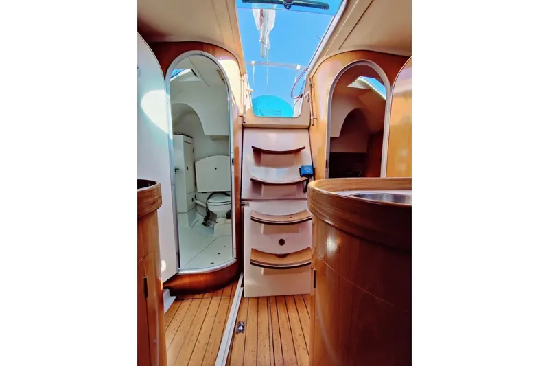Slide: The Image of Interior view of 1991 Beneteau First 38s5 sailboat, featuring wooden finishes and compact design. - 4