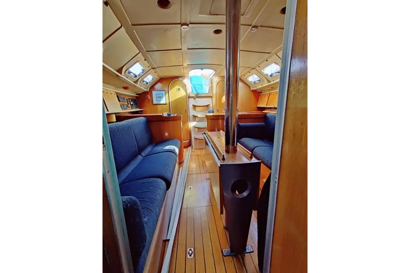 Slide: The Image of Interior of a 1991 Beneteau First 38s5 sailboat, featuring cozy seating and wooden finishes. - 5
