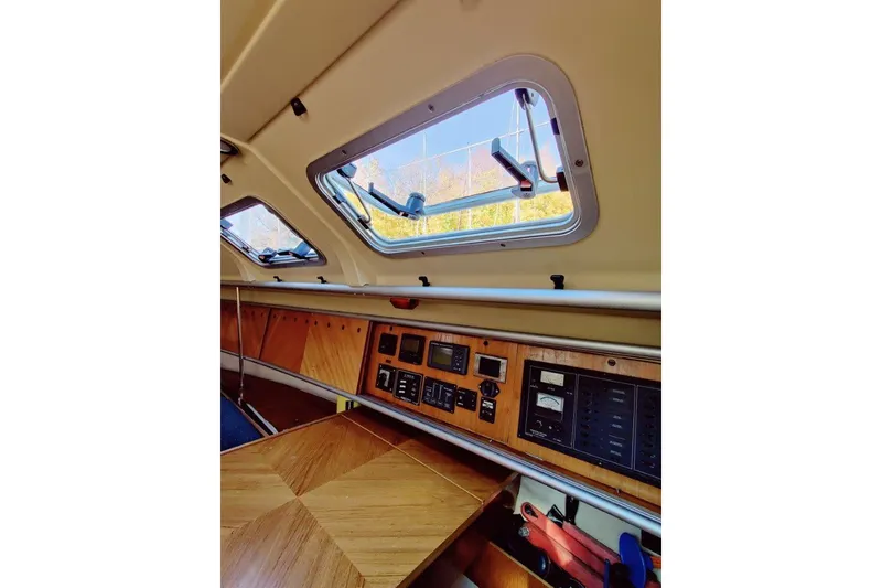 Slide: The Image of Interior view of a 1991 Beneteau First 38s5 sailboat, featuring control panels and windows. - 6