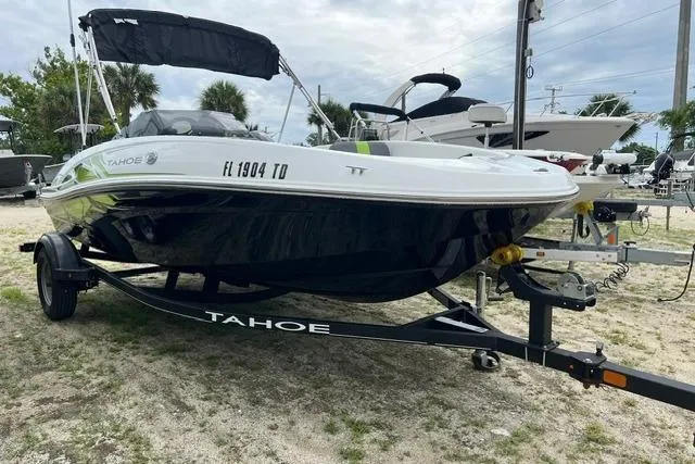 The Image of 2022 Tahoe T16 boat on trailer, parked outdoors, showcasing sleek design and modern features. - 0