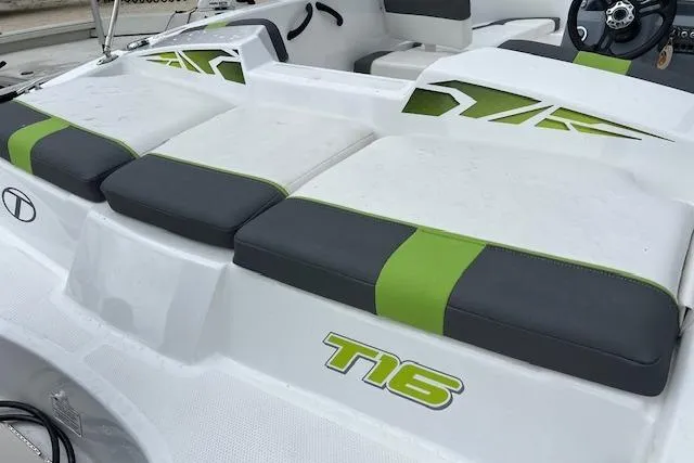 Slide: The Image of 2022 Tahoe T16 boat interior with green and gray seating accents. - 2