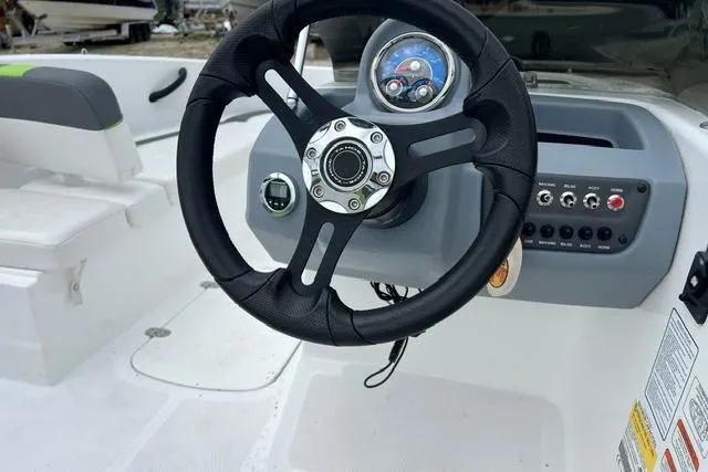 Slide: The Image of 2022 Tahoe T16 boat dashboard with steering wheel and control panel. - 6