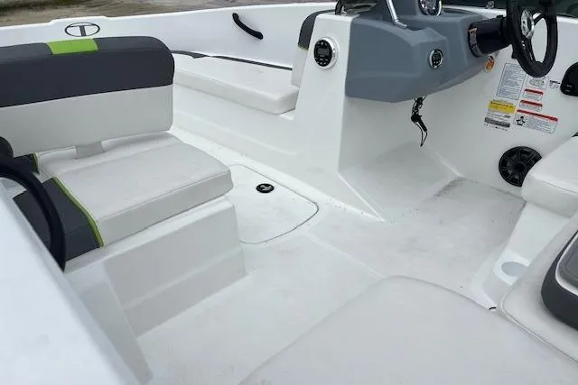Slide: The Image of 2022 Tahoe T16 boat interior with white seating and modern dashboard design. - 8