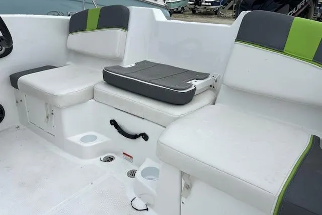 Slide: The Image of 2022 Tahoe T16 boat interior with white and green cushioned seating. - 9