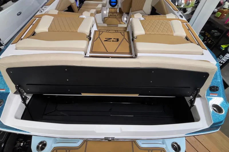 Slide: The Image of 2026 Tigé Z3 boat interior with tan seating and open storage compartment. - 10