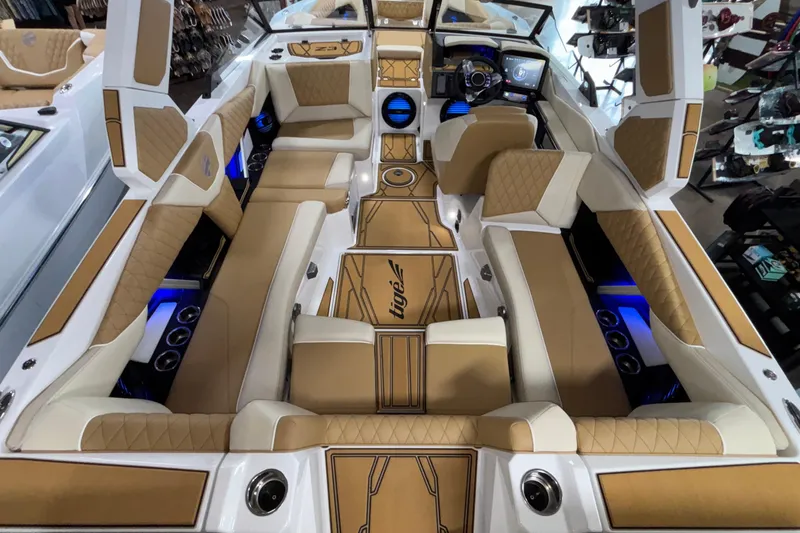 Slide: The Image of Luxurious interior of 2026 Tigé Z3 boat with tan and white seating, blue LED lighting. - 12