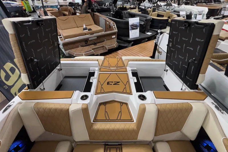 Slide: The Image of 2026 Tigé Z3 boat interior with tan and white seating, open storage compartments, and stylish design. - 14