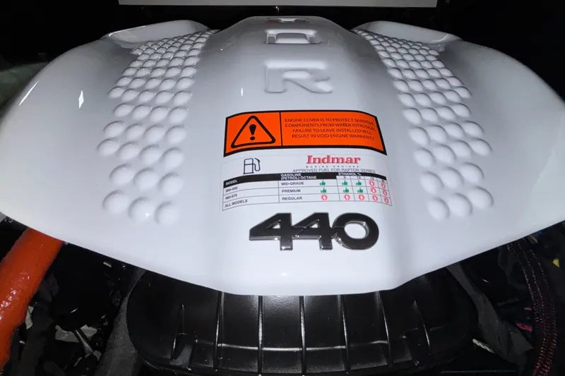 Slide: The Image of Engine cover of 2026 Tigé Z3 boat, featuring Indmar 440 model specifications and warning label. - 17