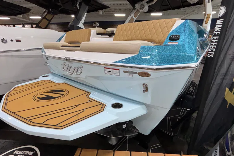 Slide: The Image of 2026 Tigé Z3 boat with blue glitter finish and tan seating on display. - 2