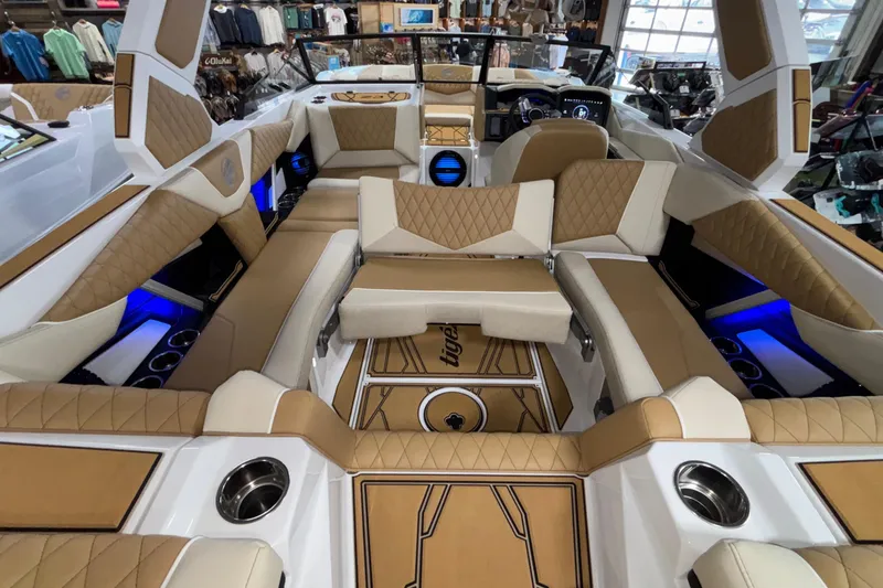 Slide: The Image of Luxurious interior of 2026 Tigé Z3 boat with tan and white seating, blue LED lighting. - 21