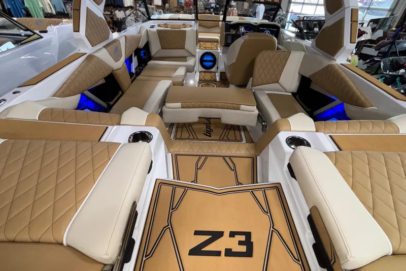 Slide: The Image of Luxurious interior of 2026 Tigé Z3 boat with tan and white seating, blue LED lighting. - 22