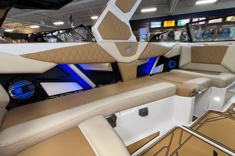 Slide: The Image of Luxurious interior of 2026 Tigé Z3 boat with tan upholstery and blue LED lighting. - 26