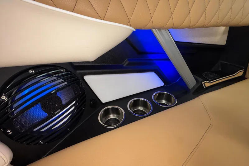Slide: The Image of Interior of 2026 Tigé Z3 boat with speaker, cup holders, and blue ambient lighting. - 28