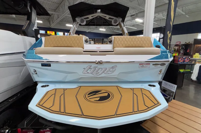 Slide: The Image of 2026 Tigé Z3 boat with sleek design and luxurious seating in showroom. - 3