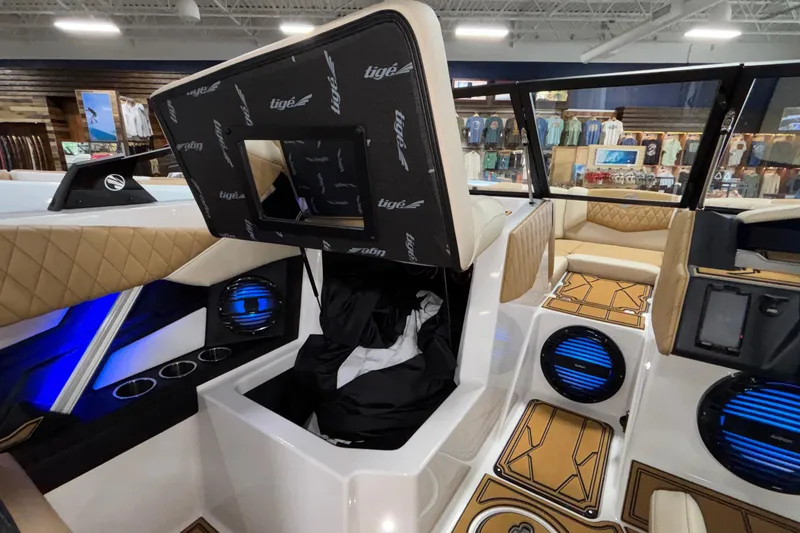 Slide: The Image of 2026 Tigé Z3 boat interior with luxury seating, blue LED lights, and storage compartment. - 32
