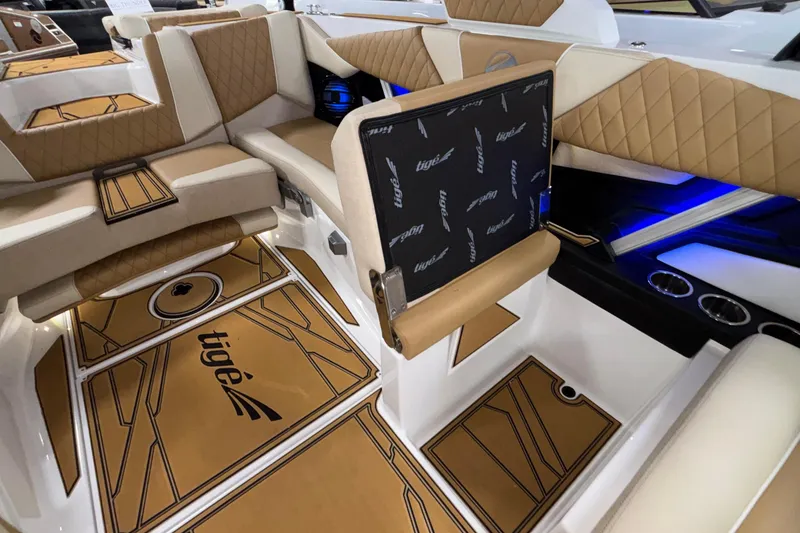 Slide: The Image of Luxurious interior of 2026 Tigé Z3 boat with tan and white seating, blue LED lighting. - 33