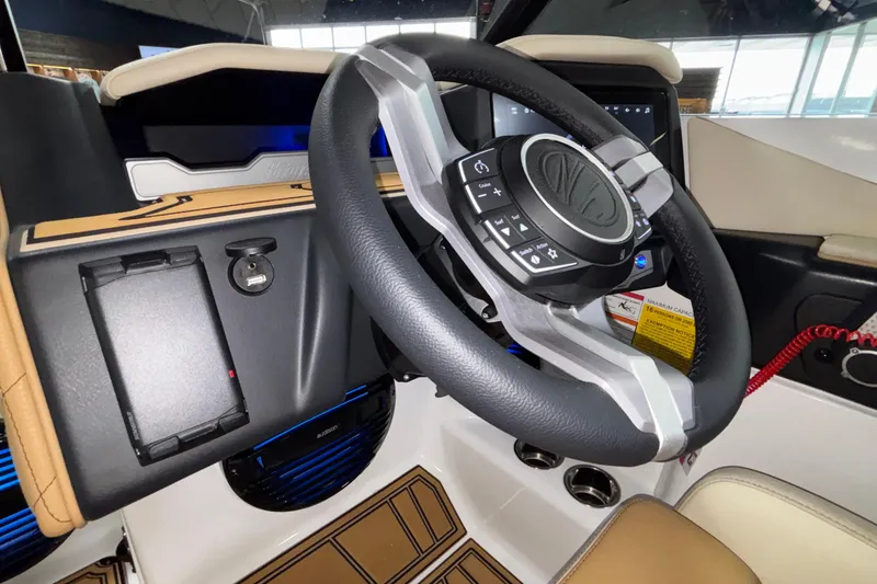 Slide: The Image of Steering wheel and dashboard of 2026 Tigé Z3 boat, featuring modern controls and sleek design. - 39