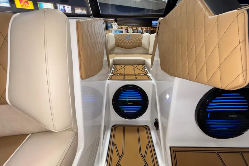 Slide: The Image of 2026 Tigé Z3 boat interior with tan diamond-stitched seats and blue-lit speakers. - 45