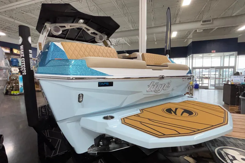 Slide: The Image of 2026 Tigé Z3 boat with sleek design and luxurious seating in showroom. - 5