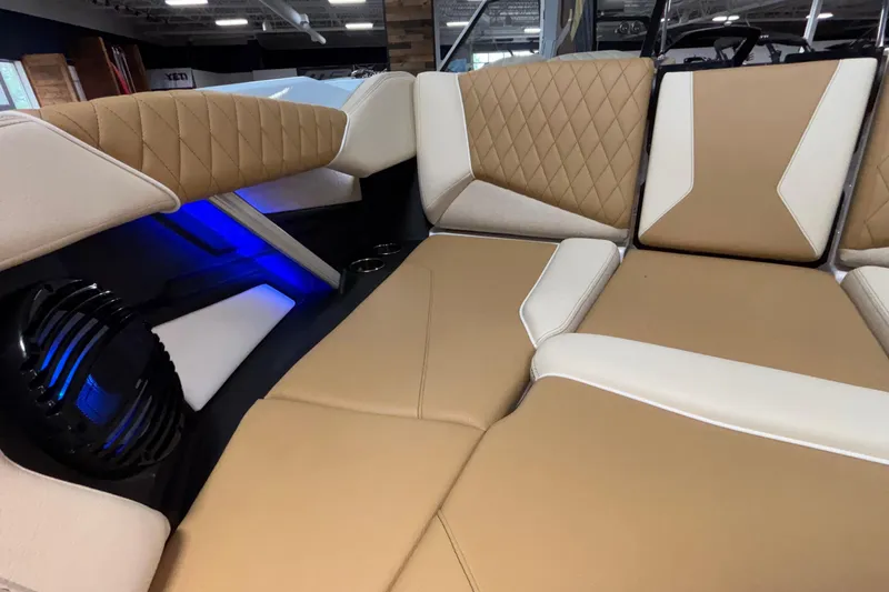 Slide: The Image of 2026 Tigé Z3 boat interior with tan and white quilted seating, blue LED lighting. - 52