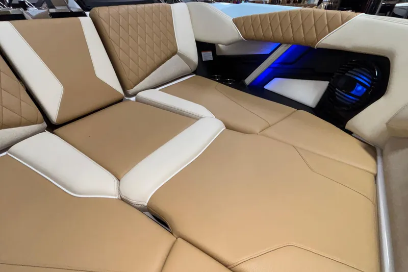 Slide: The Image of 2026 Tigé Z3 boat interior with tan and white cushioned seating and blue accent lighting. - 53