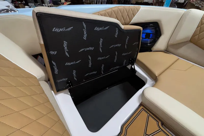Slide: The Image of 2026 Tigé Z3 boat interior with tan quilted seats and storage compartment. - 54