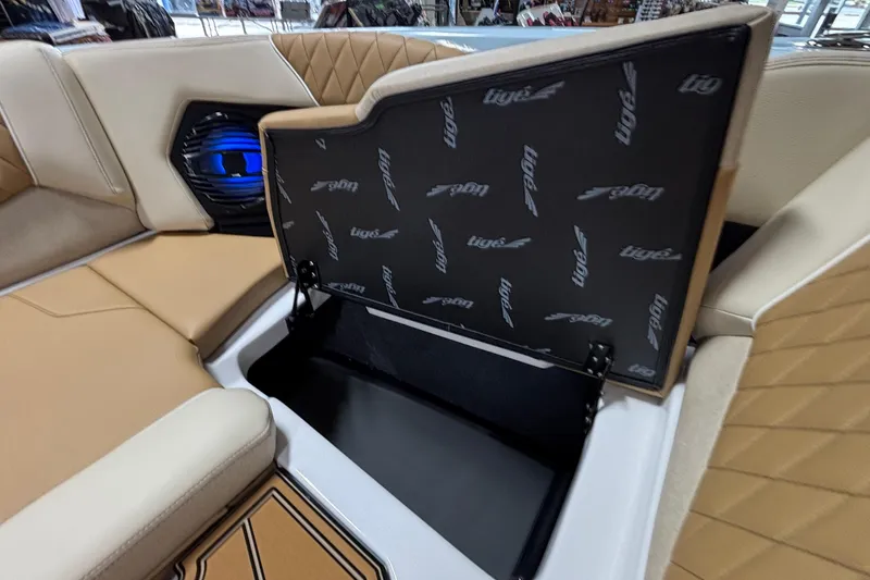 Slide: The Image of 2026 Tigé Z3 boat interior with open storage compartment and speaker system. - 55