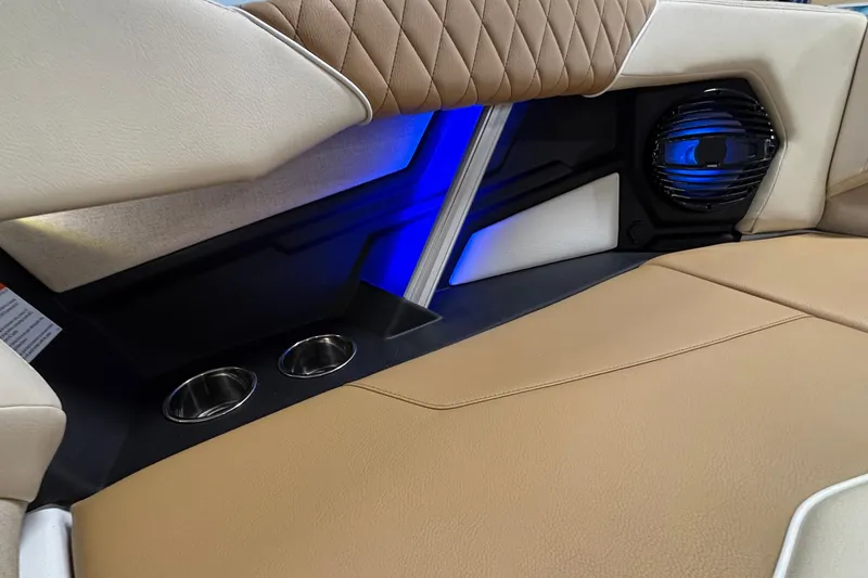 Slide: The Image of 2026 Tigé Z3 interior with tan leather seats, cup holders, and blue LED lighting. - 57