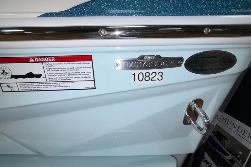 Slide: The Image of 2026 Tigé Z3 boat with warning label and identification plate, featuring a sleek design. - 9