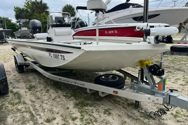 The Image of 2023 Ranger RB190 boat on trailer, parked outdoors with other boats nearby. - 1