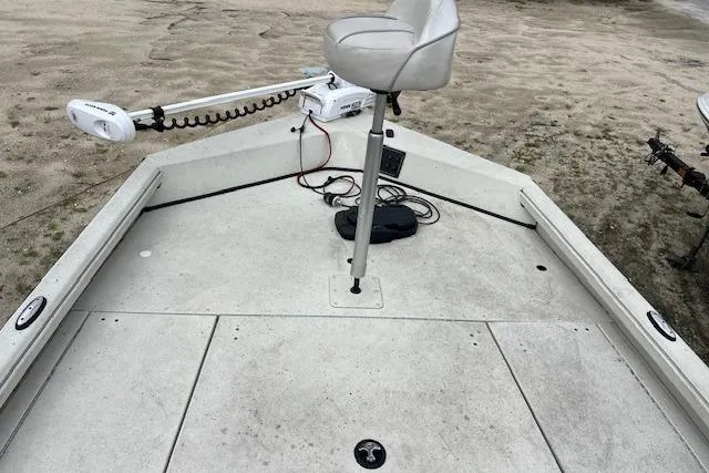Slide: The Image of 2023 Ranger RB190 boat deck with seat and trolling motor on sandy shore. - 5
