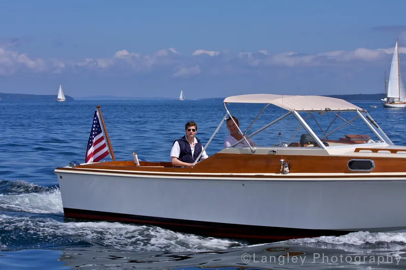 Slide: The Image of 2014 Hunt Yachts Surfhunter 25 on water with American flag. - 2