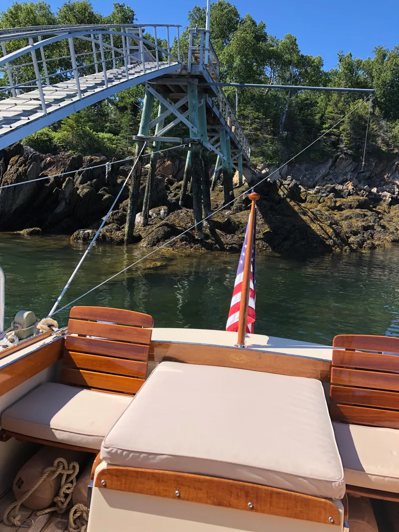 Slide: The Image of 2014 Hunt Yachts Surfhunter 25 near dock and trees. - 48