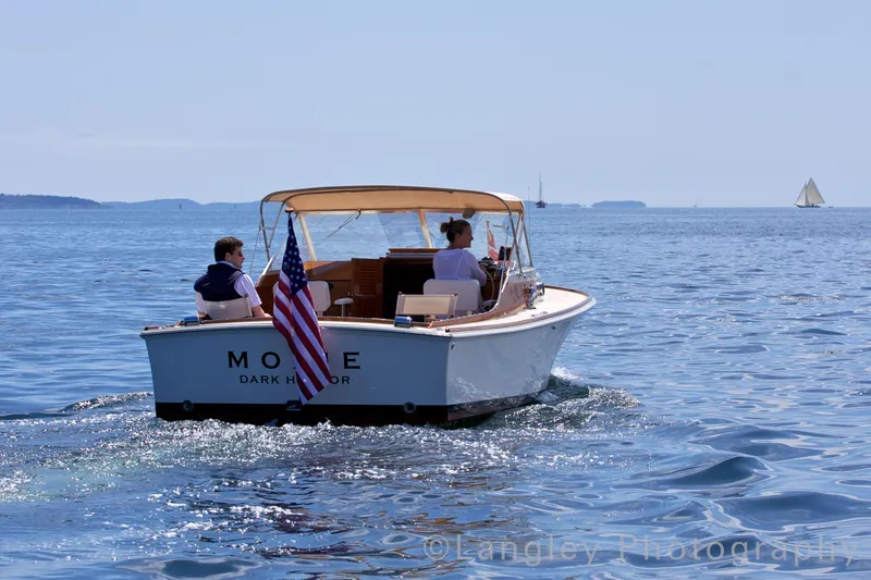 Slide: The Image of Hunt Yachts Surfhunter 25, 2014, cruising on calm sea with American flag. - 5