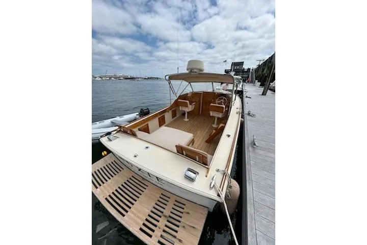 Slide: The Image of 2014 Hunt Yachts Surfhunter 25 docked, showcasing spacious deck and elegant design. - 59