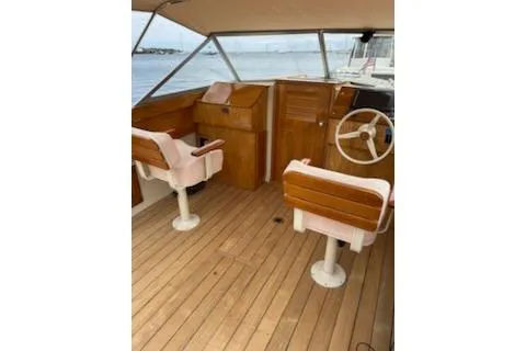 Slide: The Image of 2014 Hunt Yachts Surfhunter 25 interior with wooden helm and seating. - 63