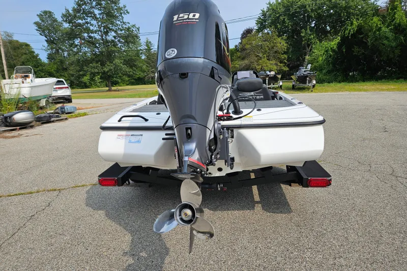 Slide: The Image of 2026 Skeeter ZX150 boat with powerful outboard motor, parked on a sunny day. - 6