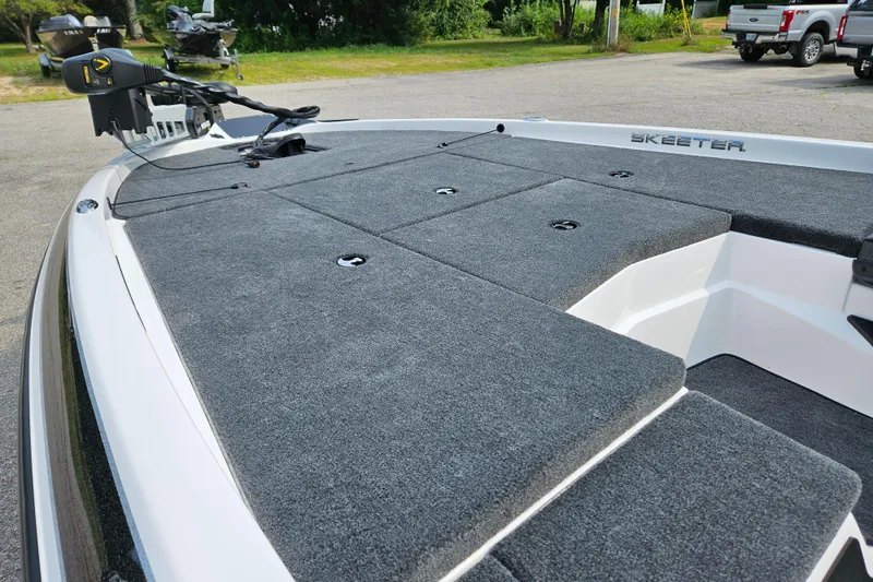 Slide: The Image of 2026 Skeeter ZX150 boat deck with carpeted surface and trolling motor. - 7