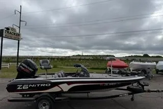 The Image of 2013 TRACKER BOATS NITRO Z6 on trailer, parked outdoors under cloudy sky. - 1