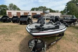 Slide: The Image of 2013 Nitro Z-6 boat on trailer, surrounded by utility vehicles and boats. - 3