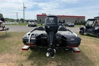 Slide: The Image of 2013 Nitro Z-6 boat with outboard motor, parked outdoors on grass. - 4