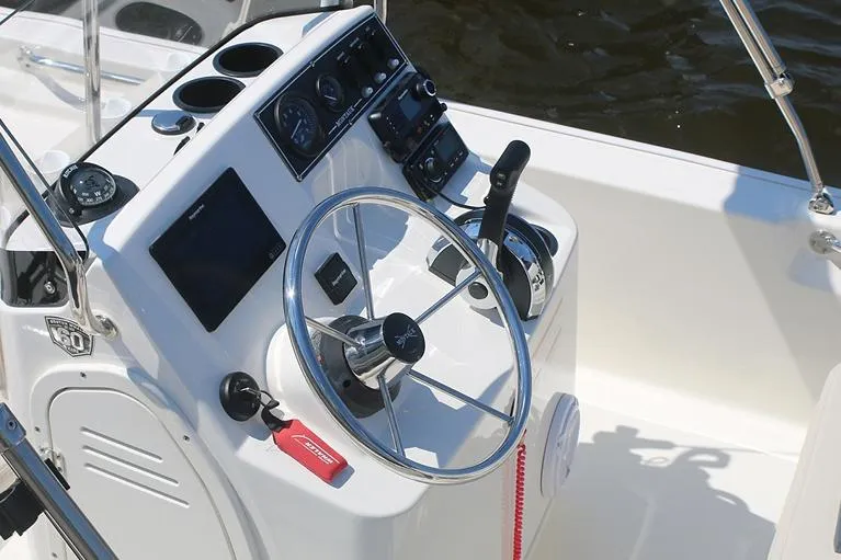 Slide: The Image of Manufacturer Provided Image: 2026 Boston Whaler 150 Montauk boat console with steering wheel and controls. - 10