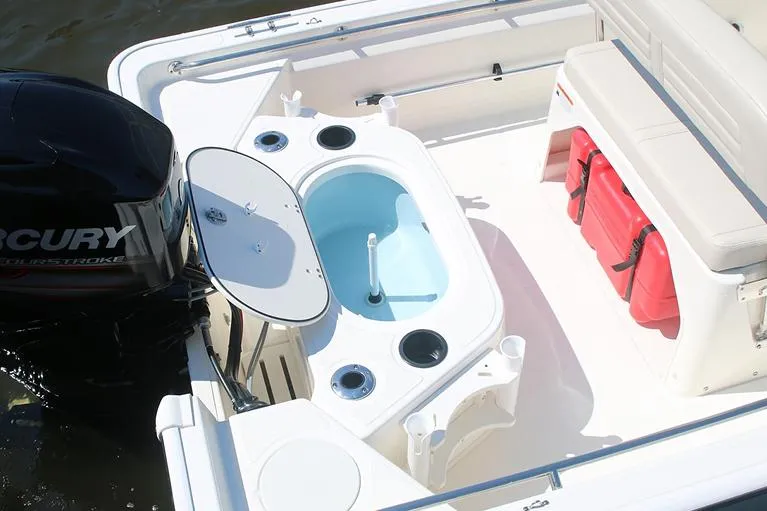 Slide: The Image of Manufacturer Provided Image: 2026 Boston Whaler 150 Montauk boat interior with Mercury engine and seating area. - 14